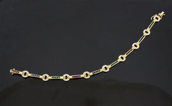 An 18ct gold, ruby, emerald, sapphire and diamond set bracelet, 7.25in.